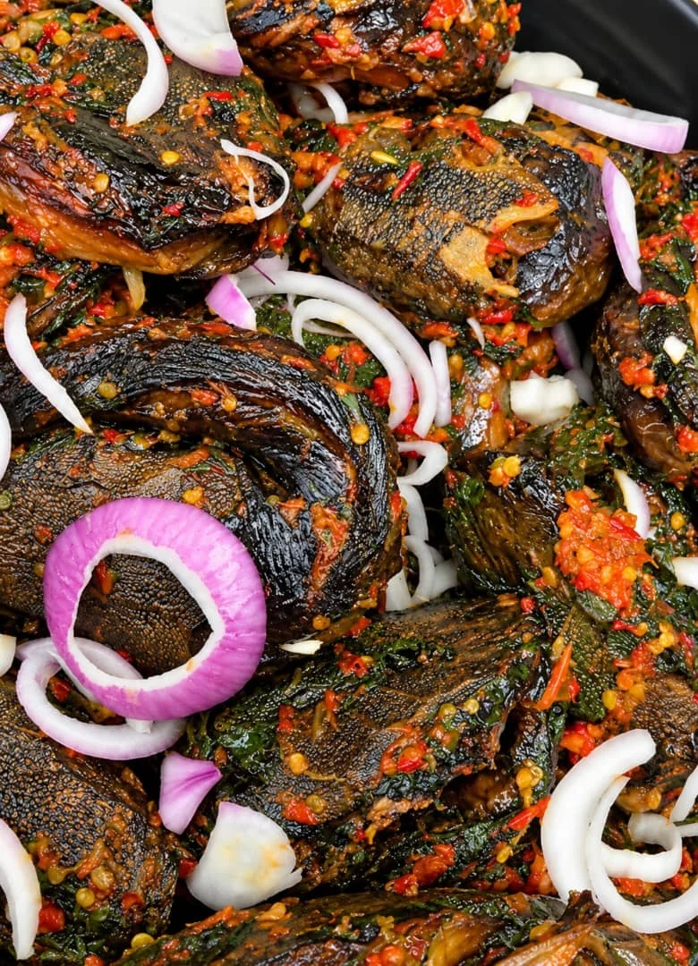 Peppered fish garnished with onion rings