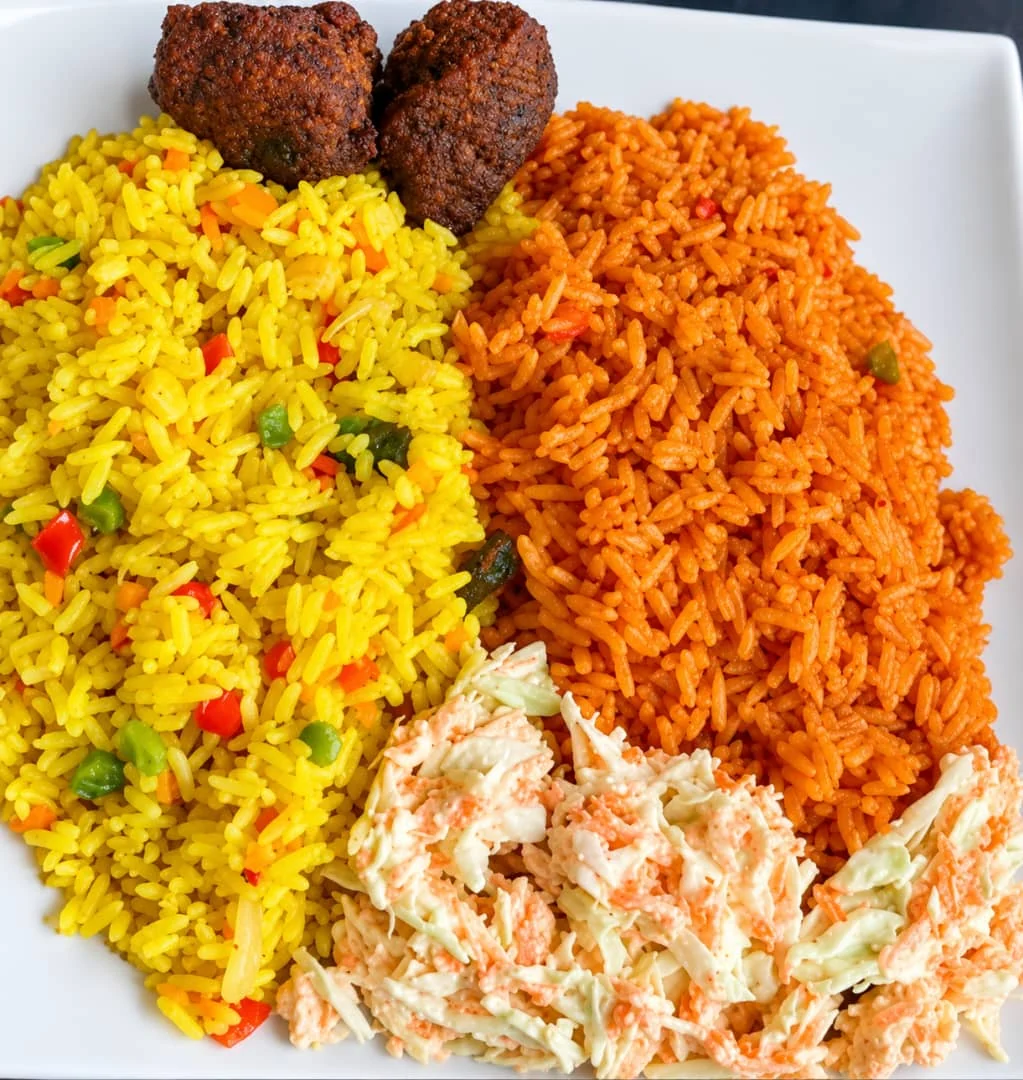 Jollof rice and yellow rice platter with sides